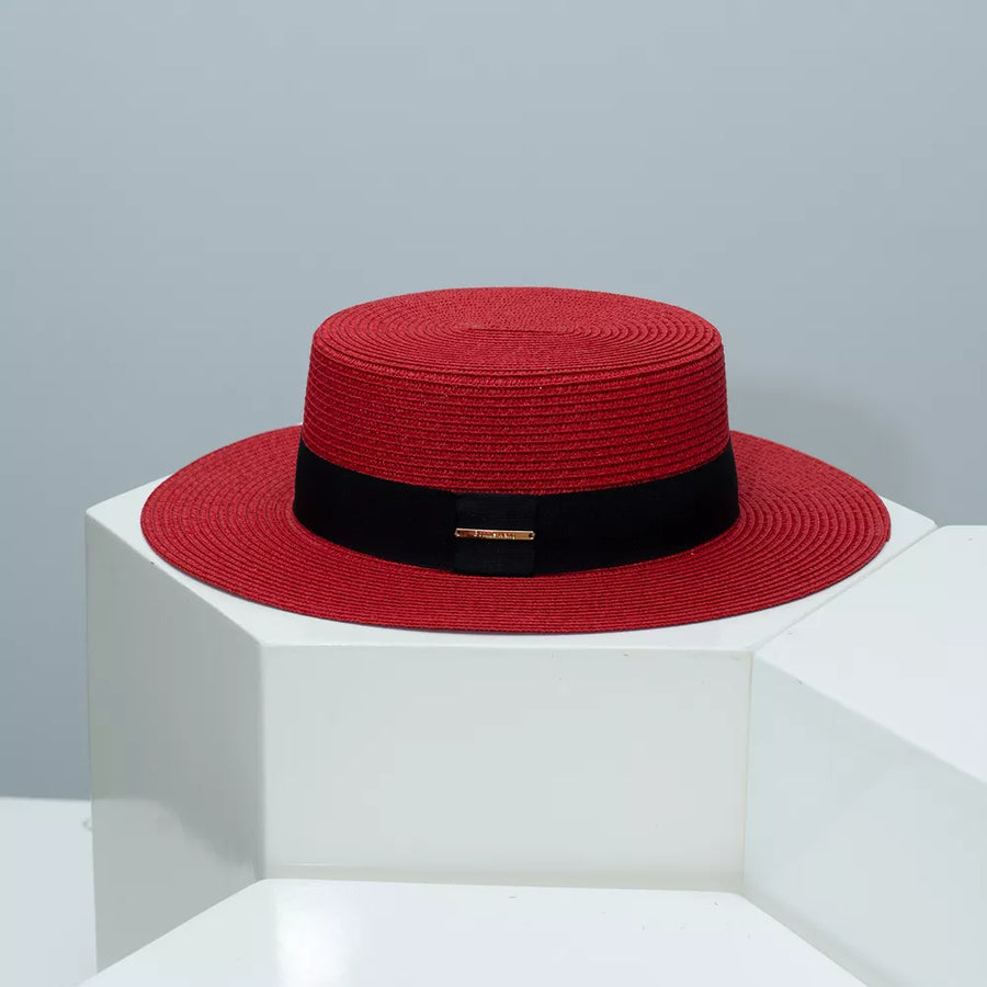 Red straw boater hat with black band and gold detail