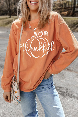 Corduroy sweatshirt in sherbet with white "thankful" pumpkin graphic.