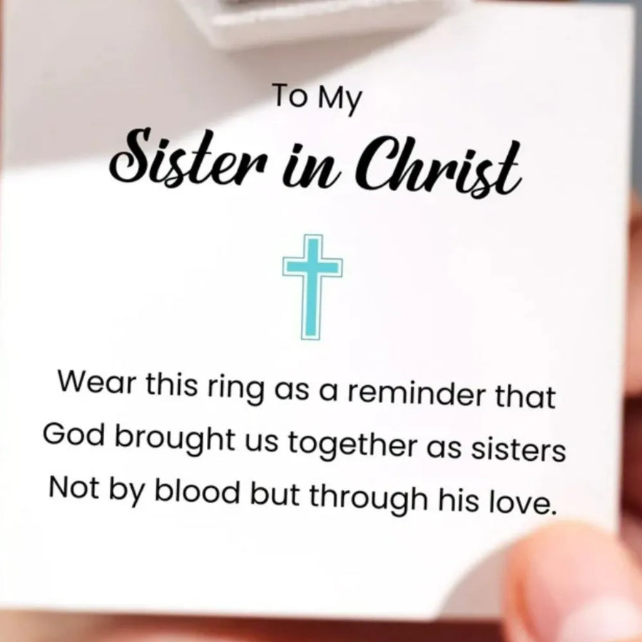 Intertwined cross sterling silver ring with blue zircon detail.