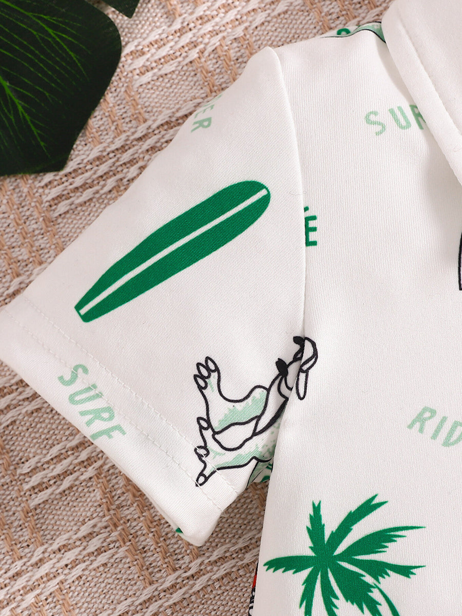 Baby polo shirt with white fabric, green dinosaur, surfboard, and palm tree print.