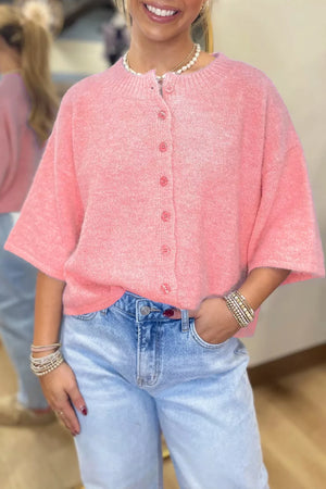 Pink boxy knit cardigan with button front and short sleeves