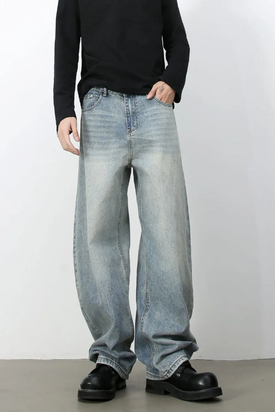 Faded baggy denim jeans in light blue with a relaxed fit.