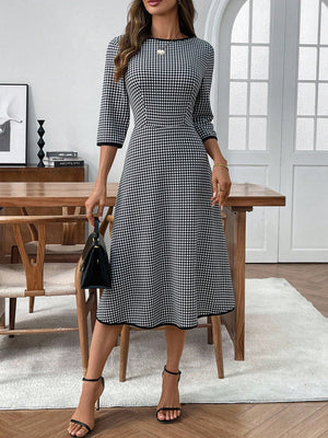 Black and white gingham midi dress with 3/4 sleeves and a-line cut.