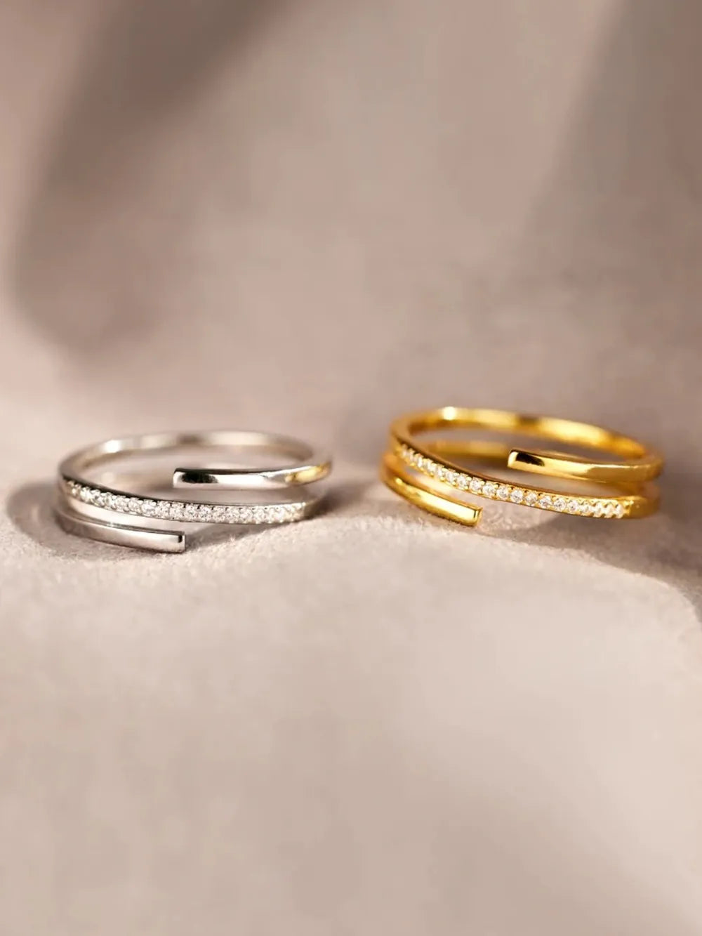 Double-band zirconia open ring in silver and gold with pave crystal accents.