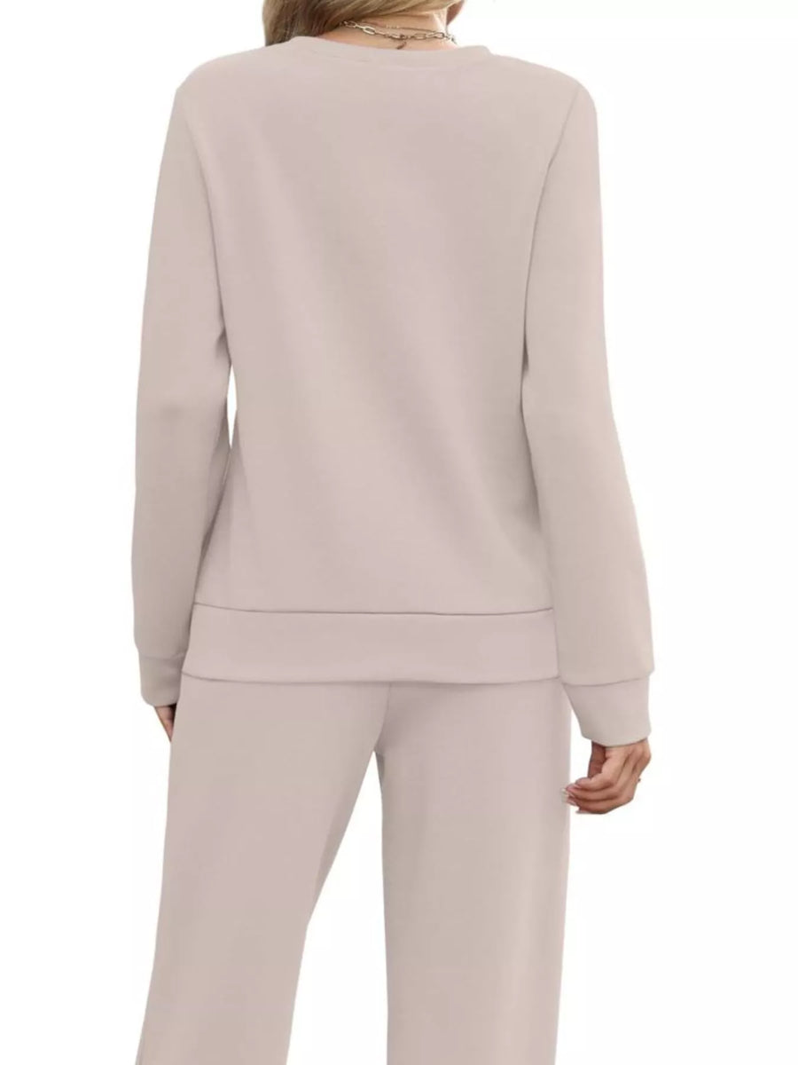 Casual long-sleeve top and pants set in apricot with crew neck and wide leg pants.