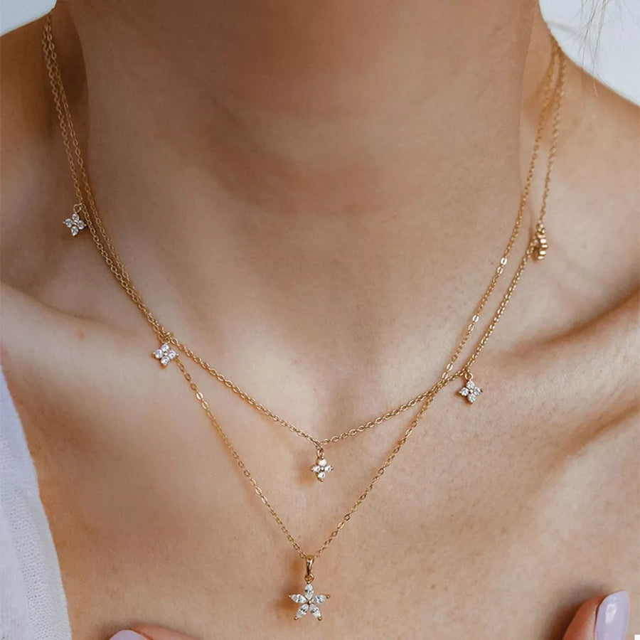 Gold double layer necklace with star and flower charms with clear stones