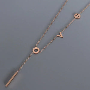 Rose gold necklace with LOVE letter charms and a bar pendant.
