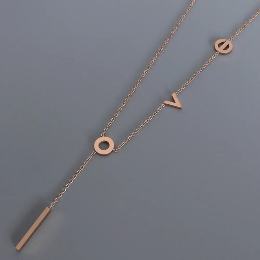 Rose gold necklace with LOVE letter charms and a bar pendant.