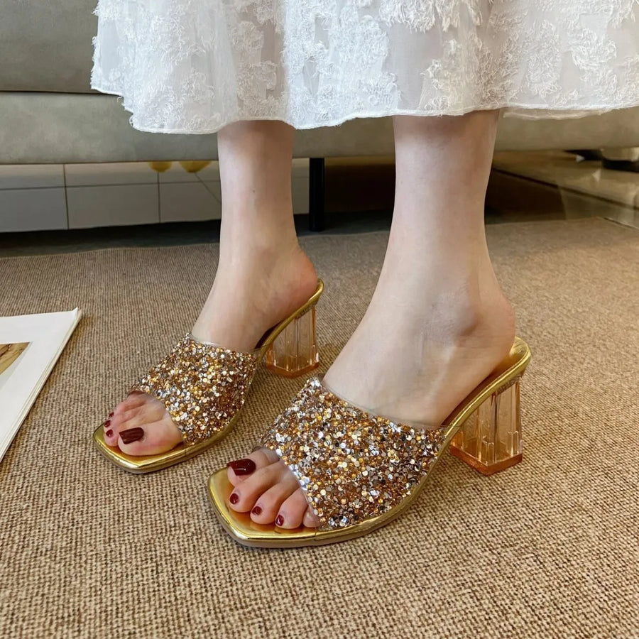 Gold glitter embellished lucite heel mules with clear block heel.