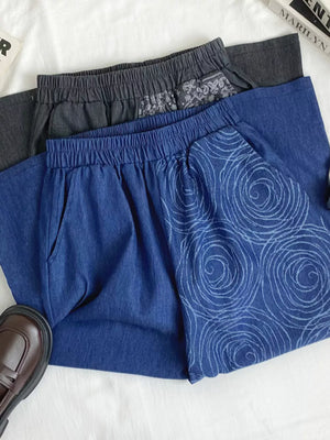 Blue comfort jeans with rose print and grey jeans with paisley print detail.