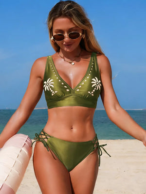 Green palm tree cutout bikini with lace-up sides and V-neck top.
