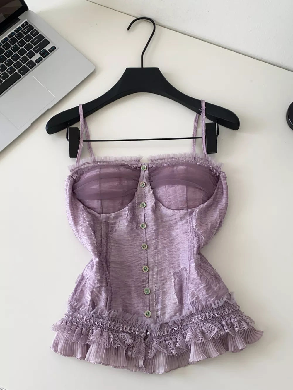 Purple lace ruffle hem tank top with button front and sheer bust detail.