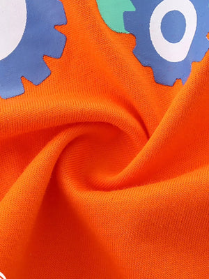 Orange cotton toddler underwear with playful tractor and firetruck graphic detail.
