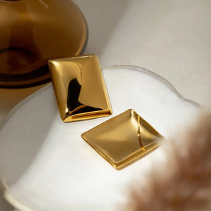 Sculpted gold rectangle earrings with a polished finish.