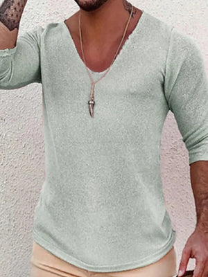 Textured slouchy V-neck knit top in sage with 3/4 sleeves and a raw hem.
