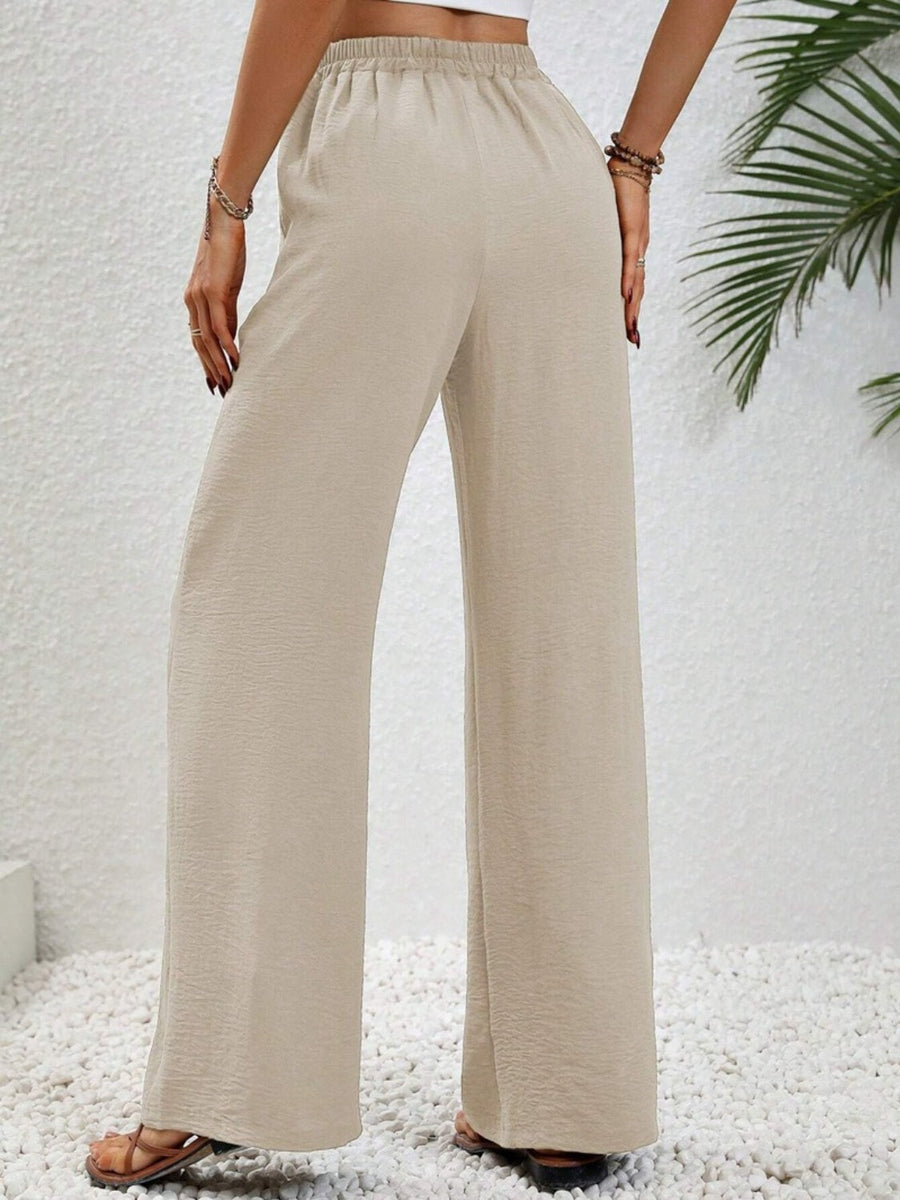 Textured palazzo trousers in cream with a drawstring waist and wide legs.