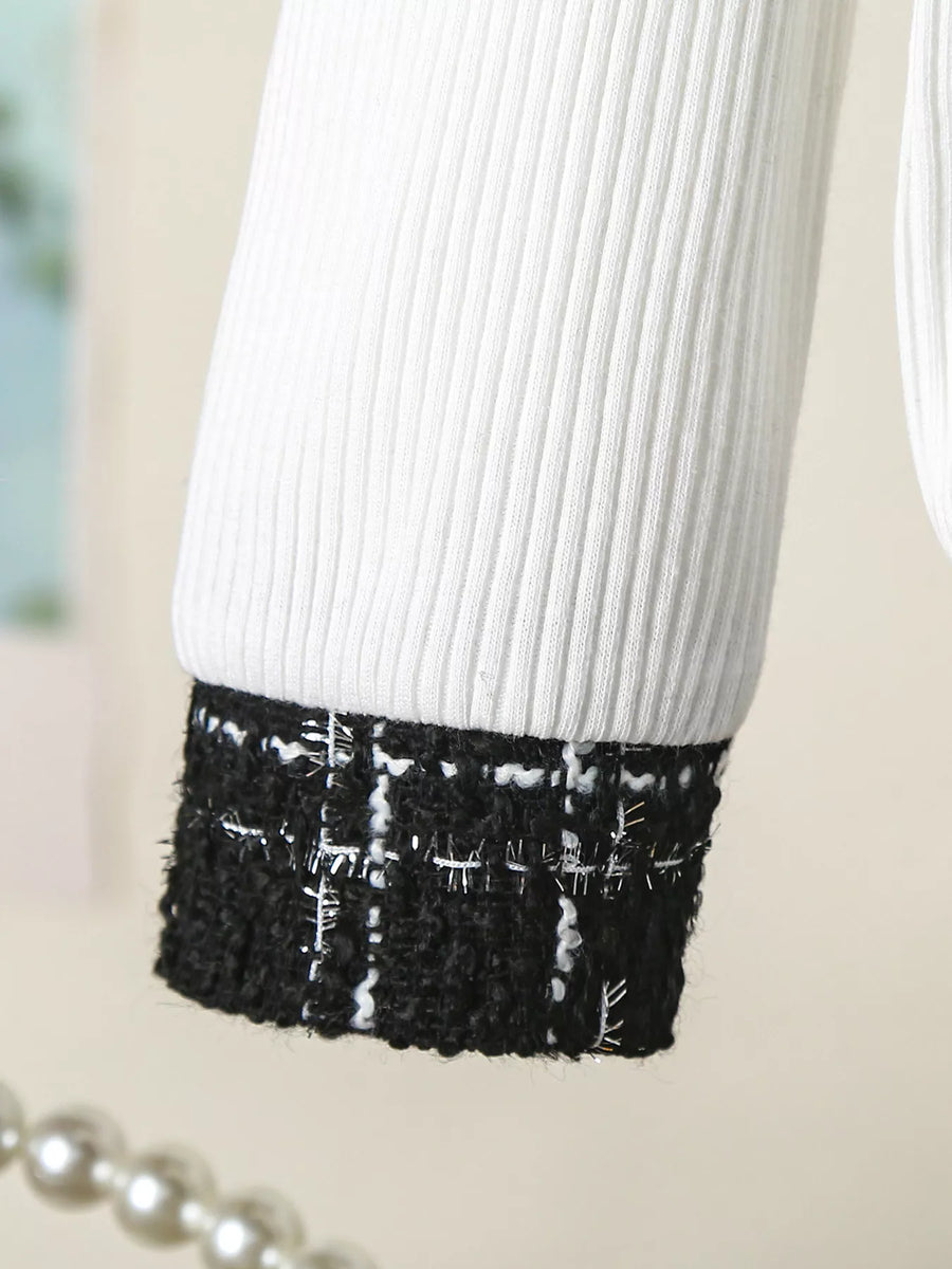 White ribbed baby top with black plaid tweed cuff detail