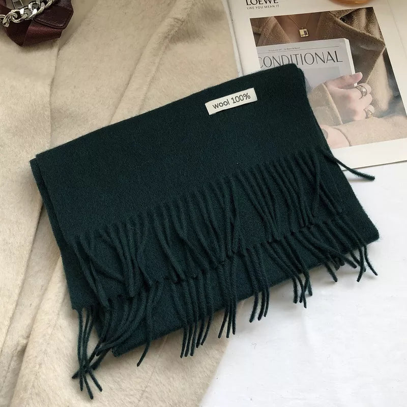 Army green wool knit scarf with fringes and a "wool 100%" tag.