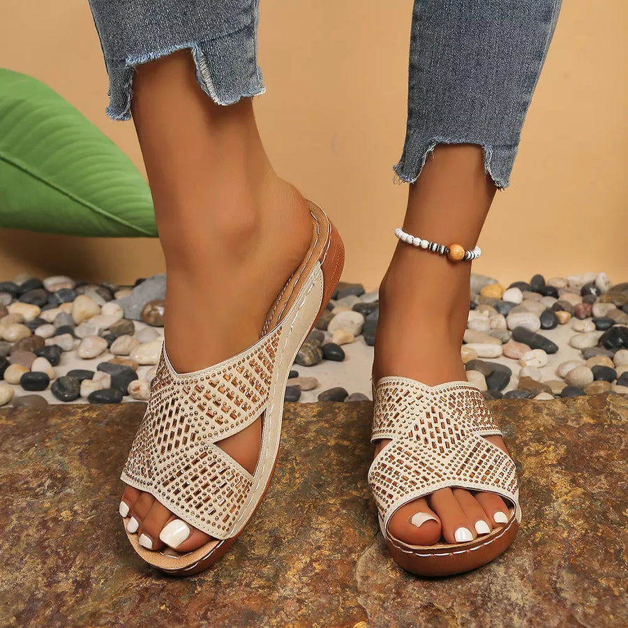 Off-white rhinestone-embellished criss-cross open toe wedge sandals with comfortable platform sole.
