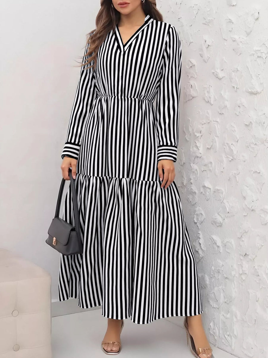 Notched long-sleeve midi dress in black and white stripes with a tiered skirt.
