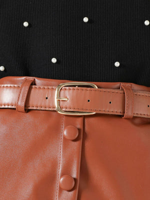 Black pearl-embellished top with brown faux leather skirt and belt