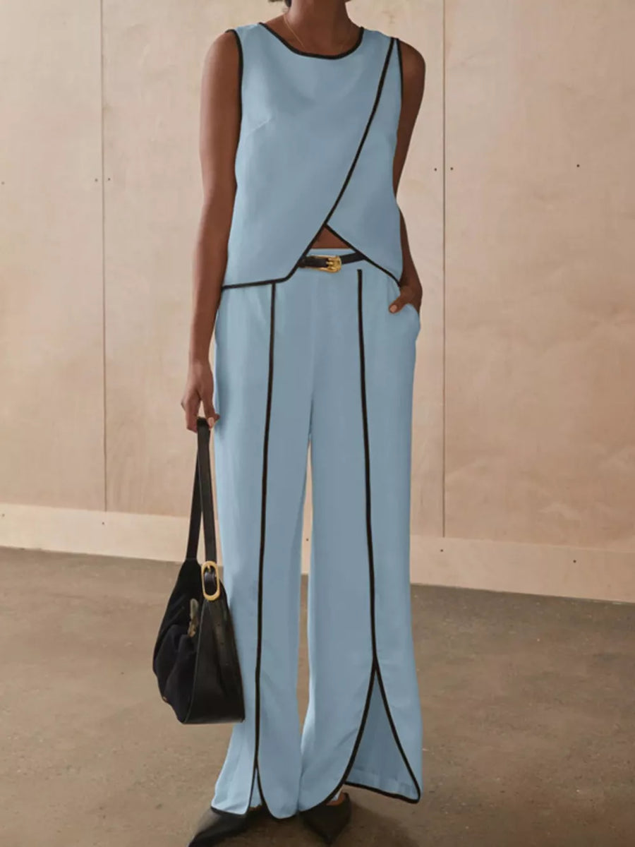 Light blue sleeveless top with black trim and matching wide-leg pants with black trim and side slits.