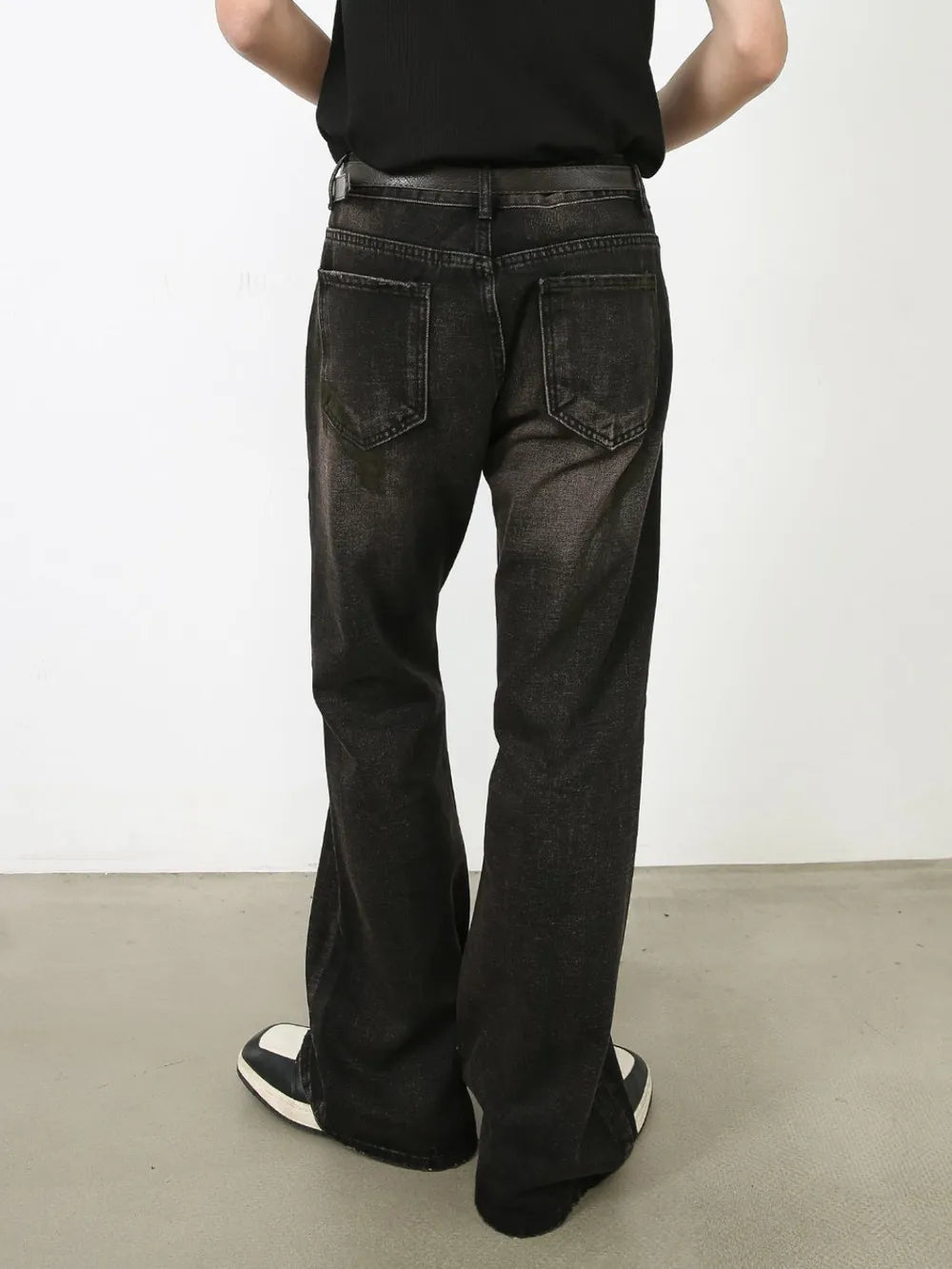 Faded flare jeans in dark distressed wash denim with a buttoned fly and classic five-pocket styling.