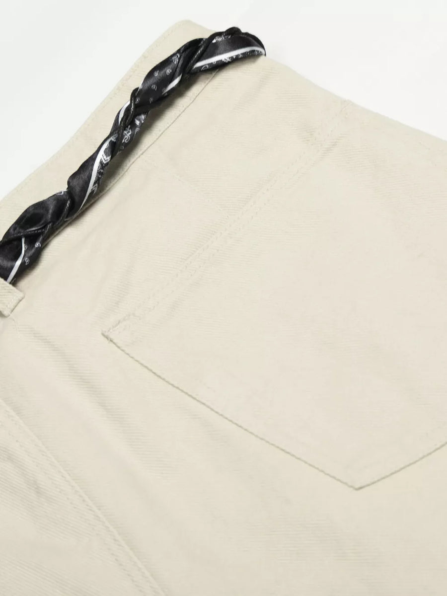 Cream white maternity pants with a black paisley print braided belt detail.