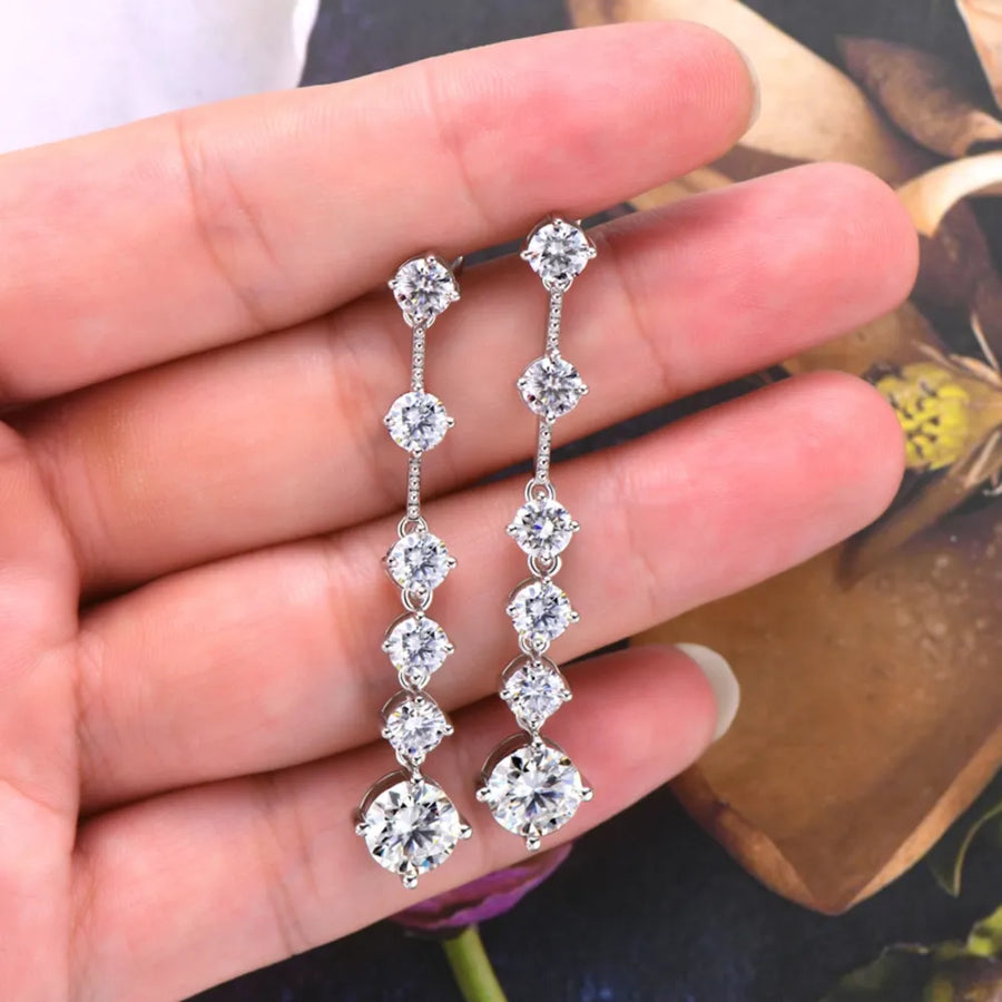 Silver cascading diamond drop earrings with multiple round-cut stones.