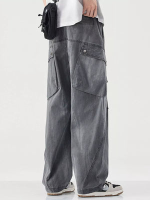 Loose fit grey cargo pants with multiple pockets and drawstring detail.