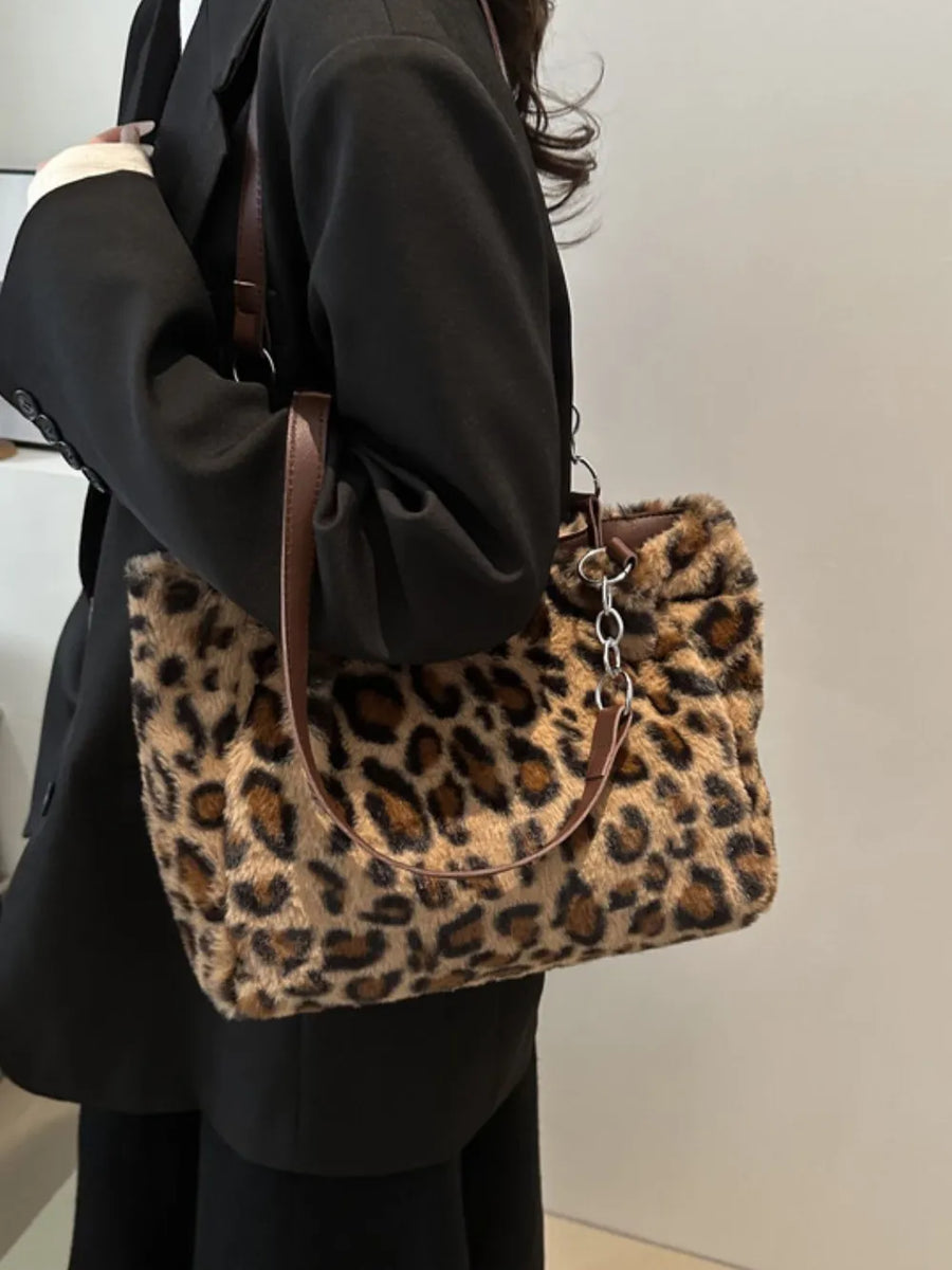 Leopard print faux fur shopper bag with chain handle and brown leatherette straps.