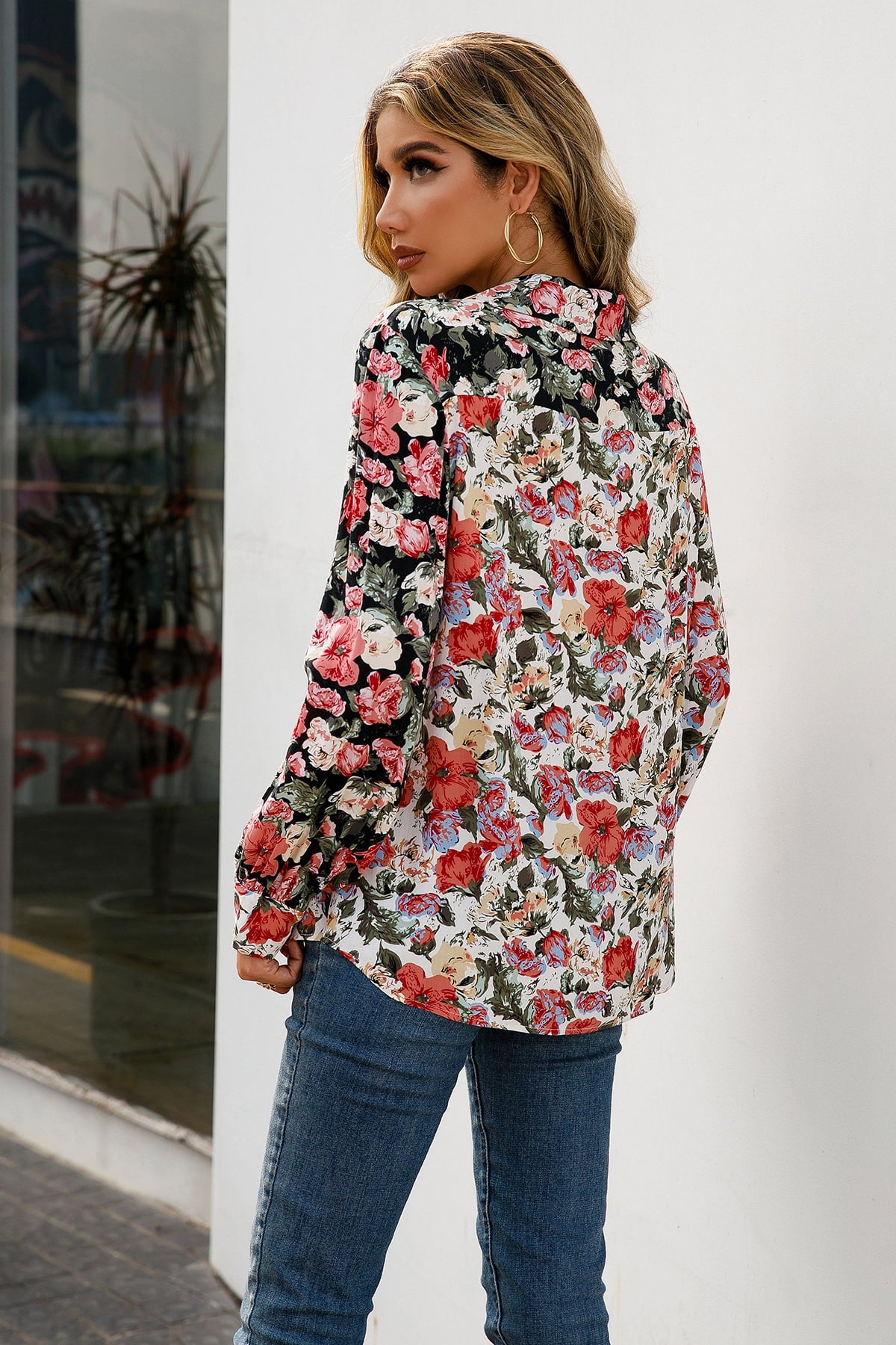 Floral print button-down blouse with gathered sleeves and a collared neckline.