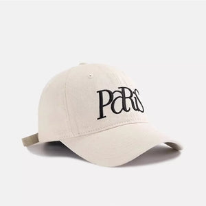 Baseball cap in cream cotton with black embroidered Paris text and adjustable strap.