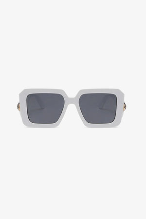 White geometric facet sunglasses with embellished temples and dark lenses.
