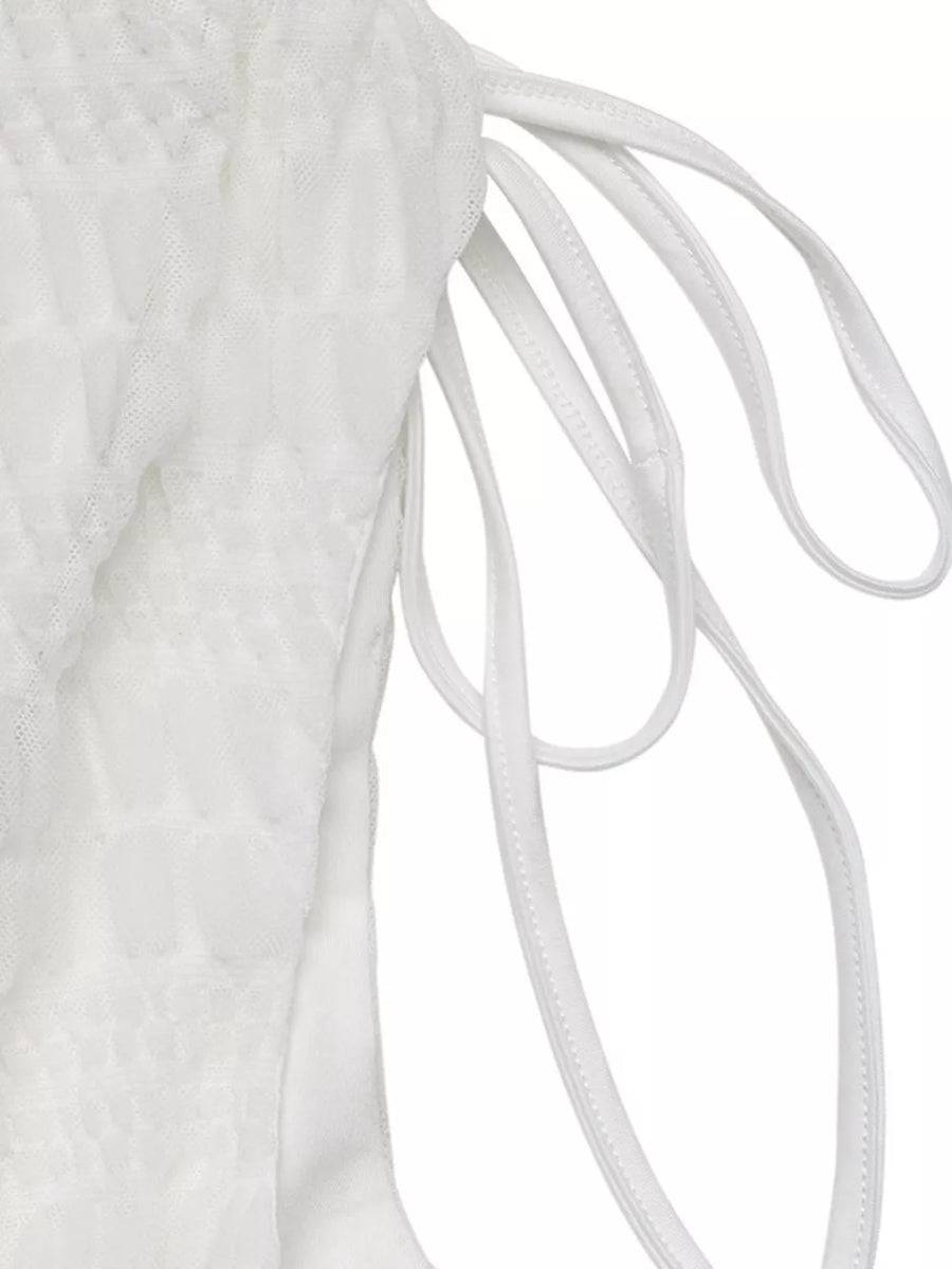 White textured smocked dress with deep V-neck and adjustable tie straps.