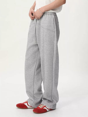 Gray cotton drawstring sweatpants with wide legs and a tailored fit.