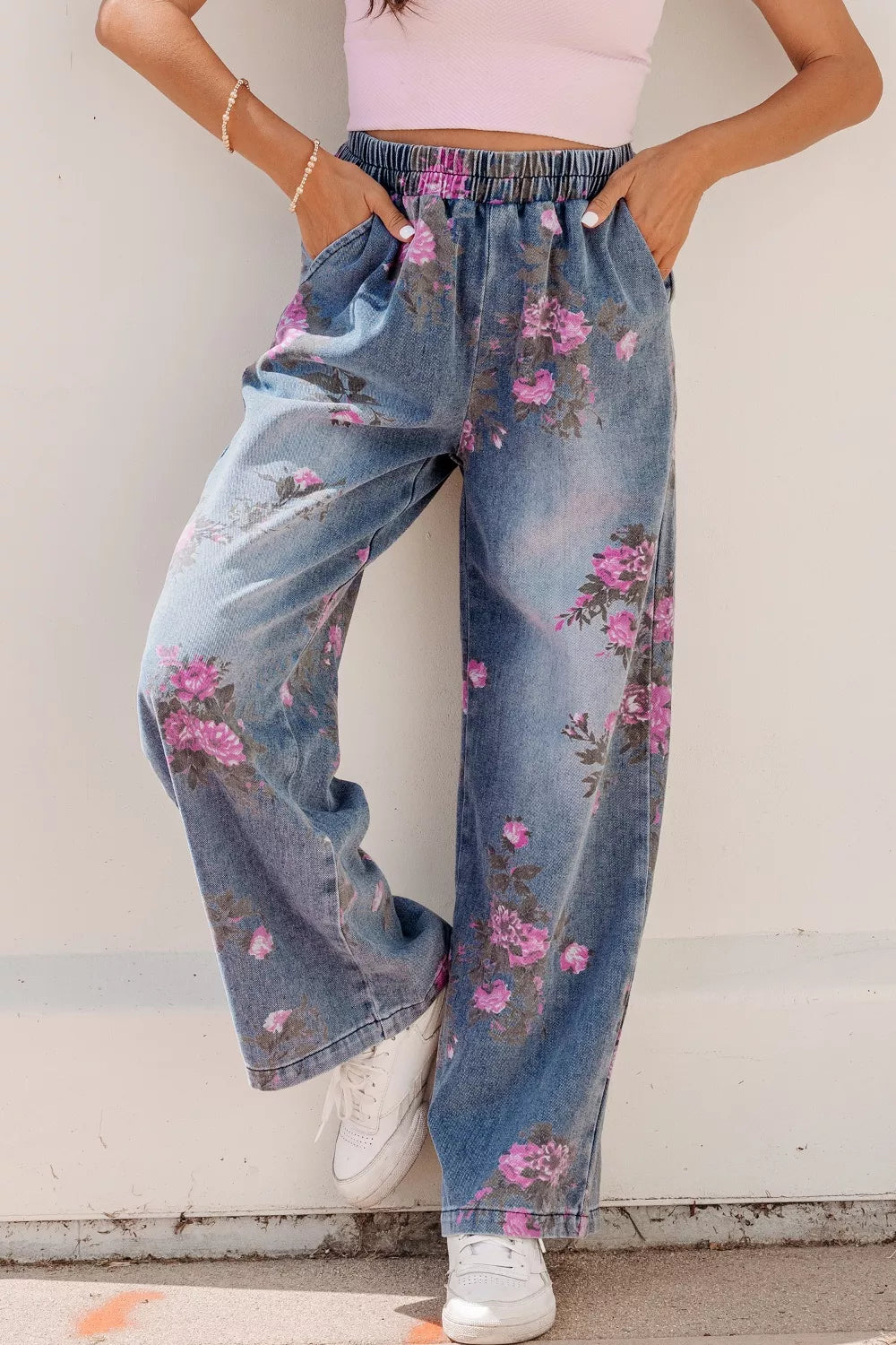 Floral wide-leg jeans in denim with an elastic waistband and pink floral print.