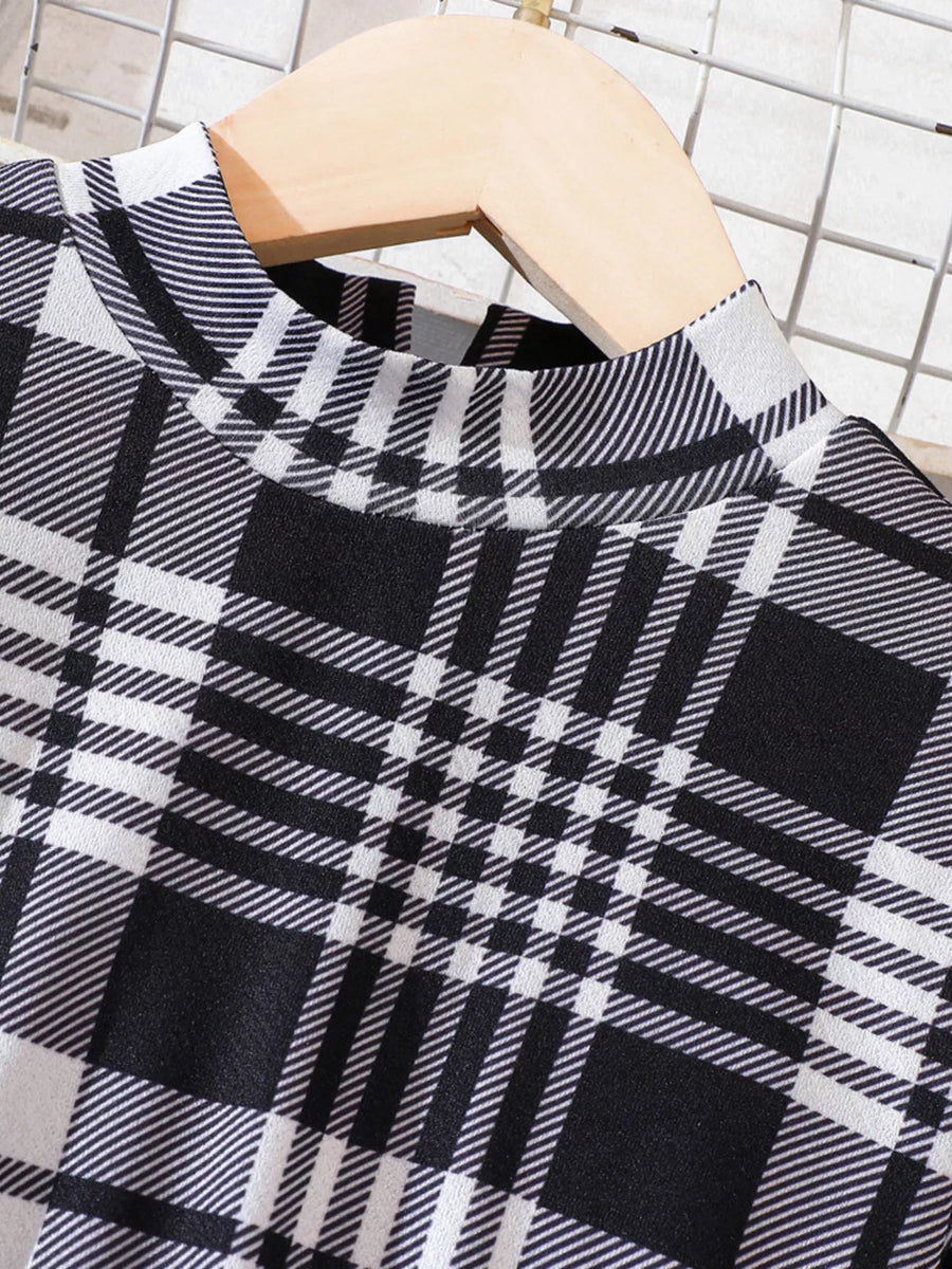 Black and white plaid baby dress with mock neck and long sleeves.