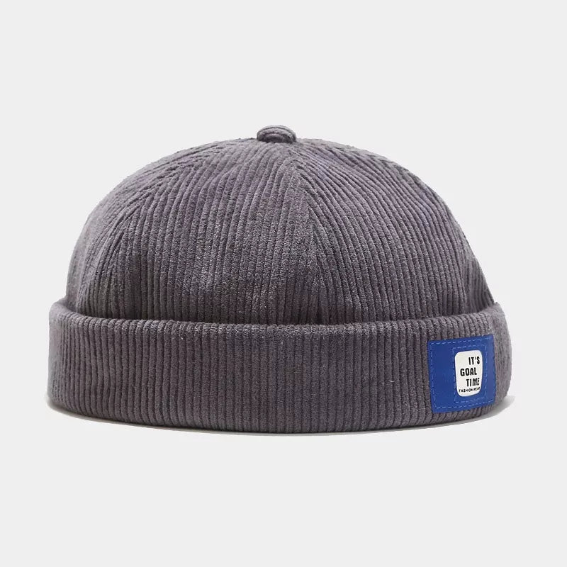 Beige hat with ribbed texture and na