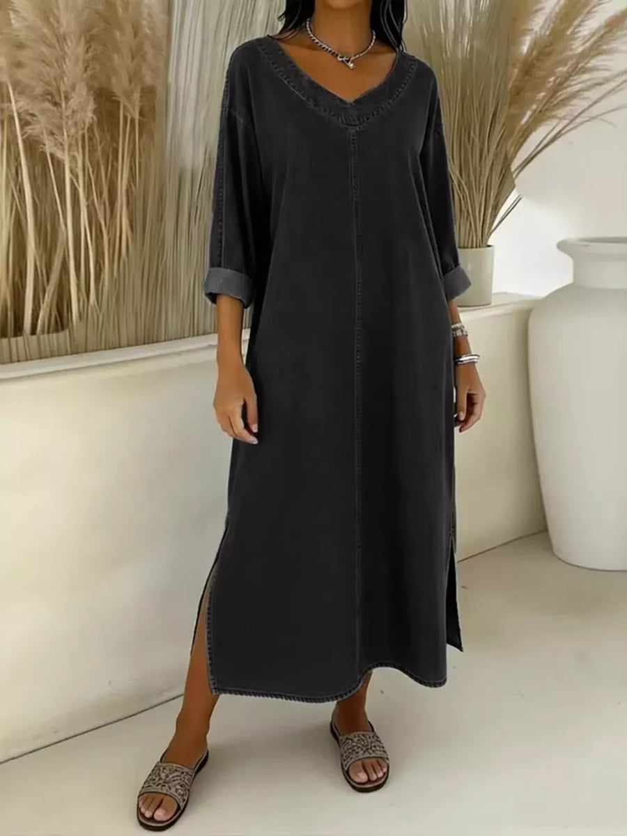Dark blue midi dress with V-neck, long sleeves, and side slits.