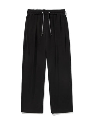 Black oversized drape-front lounge trousers with drawstring waist and wide leg.