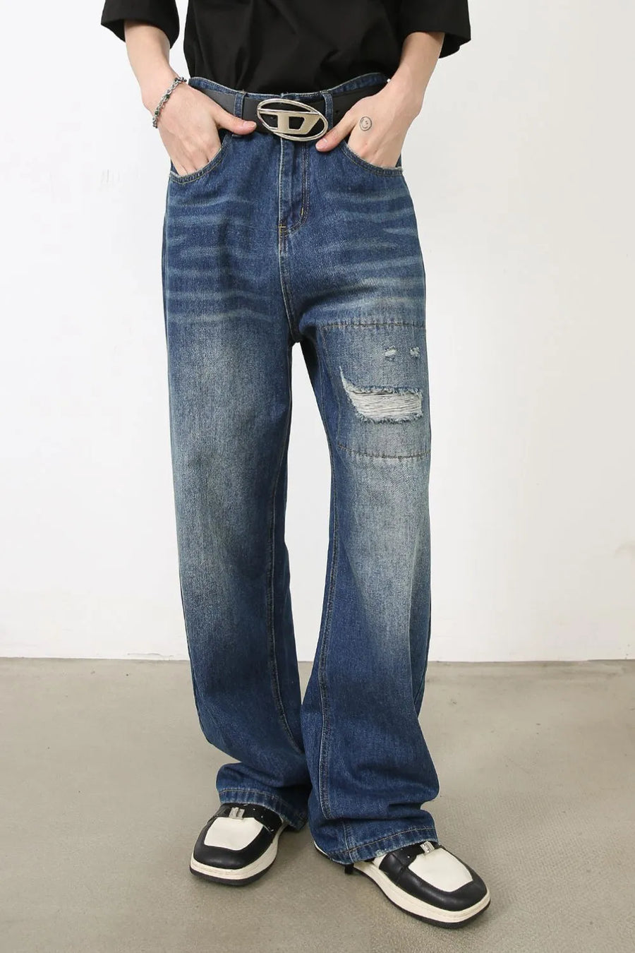 Baggy patchwork denim jeans in medium vintage wash with distressed details.