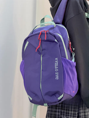 Purple nylon casual backpack with red rope zipper pulls and light green trim.