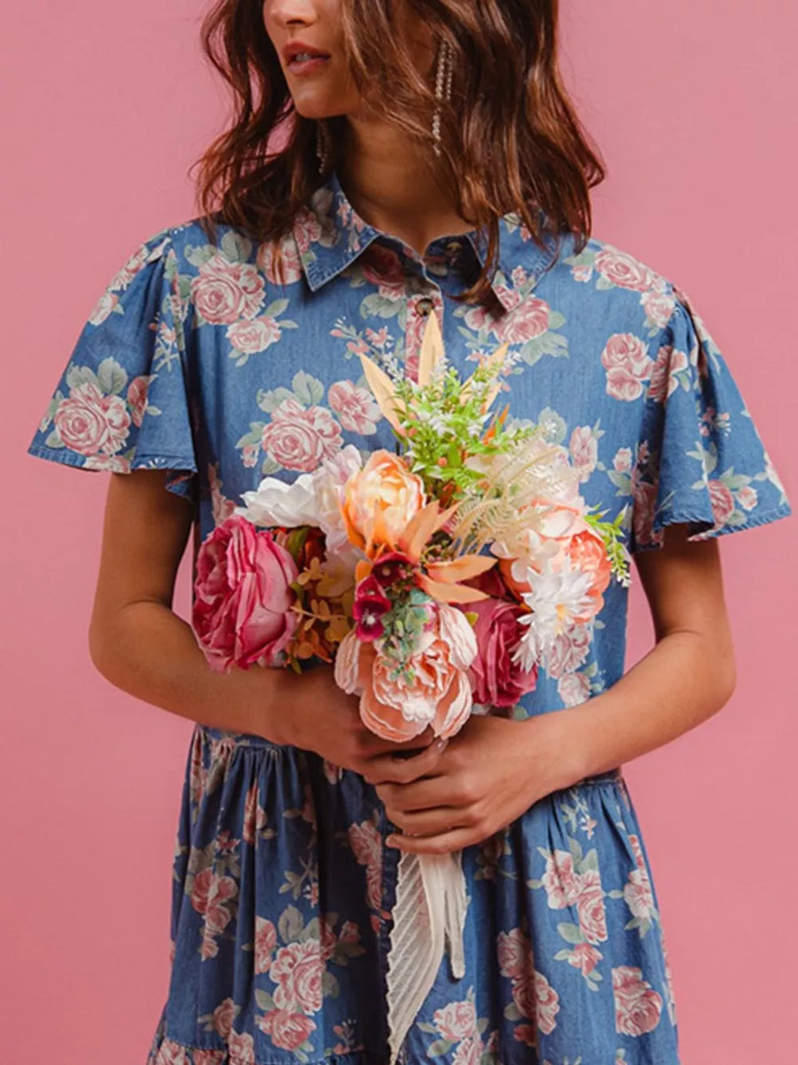 Floral denim mini dress with ruffled details and short sleeves, featuring a button-up collar.