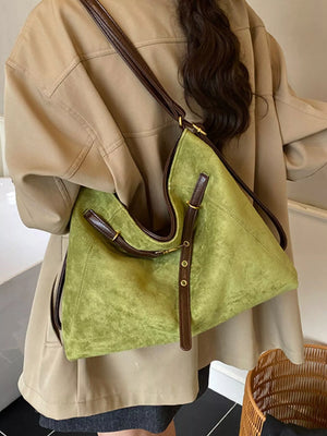 Green suede large tote bag with brown leather trim and gold hardware.