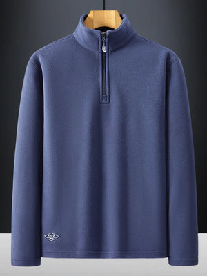 Plus-size dark blue quarter zip sweatshirt with a stand-up collar and subtle embroidered logo detail.