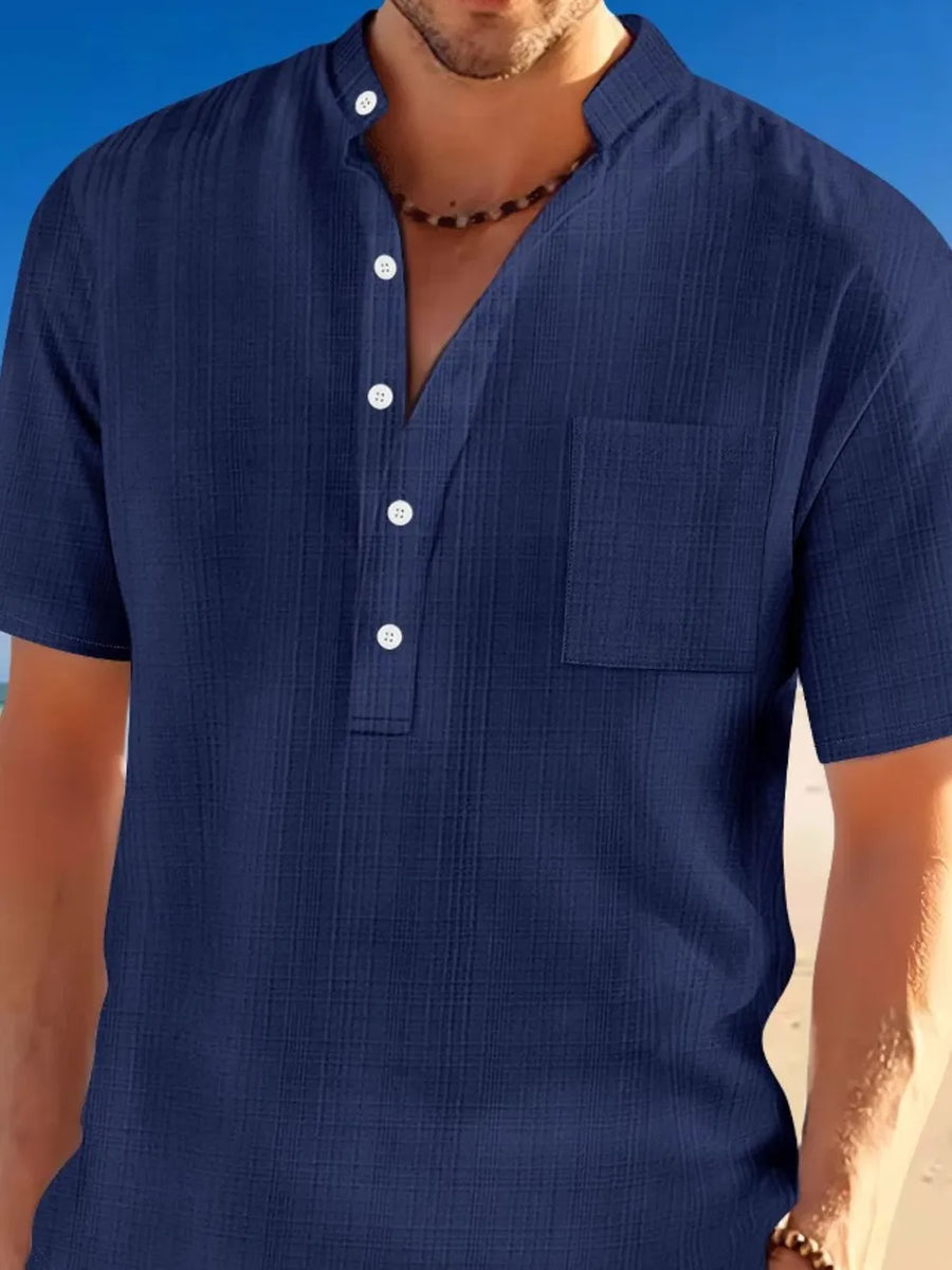 Navy textured linen henley shirt with mandarin collar and chest pocket.