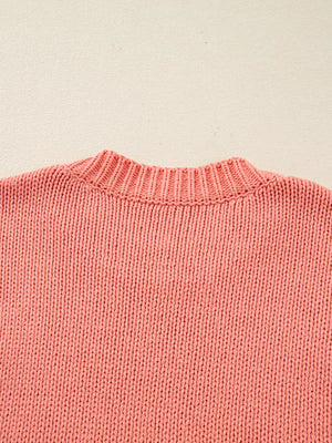 Burnt coral knit sweater with ribbed crewneck and textured stitch detail.