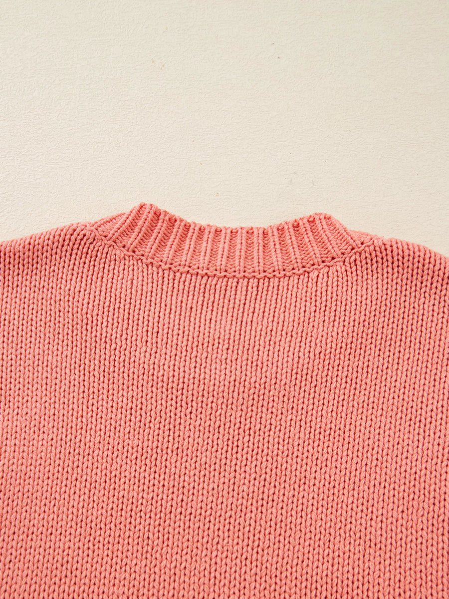 Burnt coral knit sweater with ribbed crewneck and textured stitch detail.