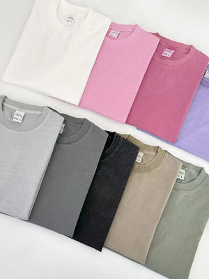 Oversized pigment-dyed crewneck tees in Gray, Dark Gray, Black, Khaki, Matcha Green, Pink, Hot Pink, Lavender, and Ivory.
